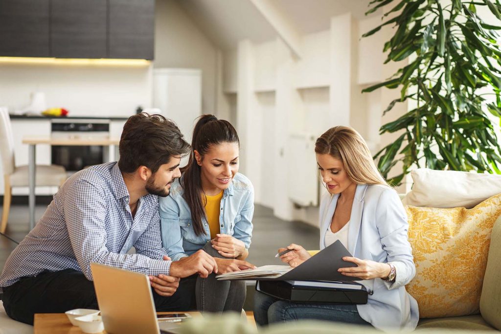 couple discussing investing in their 30s with a financial planner.