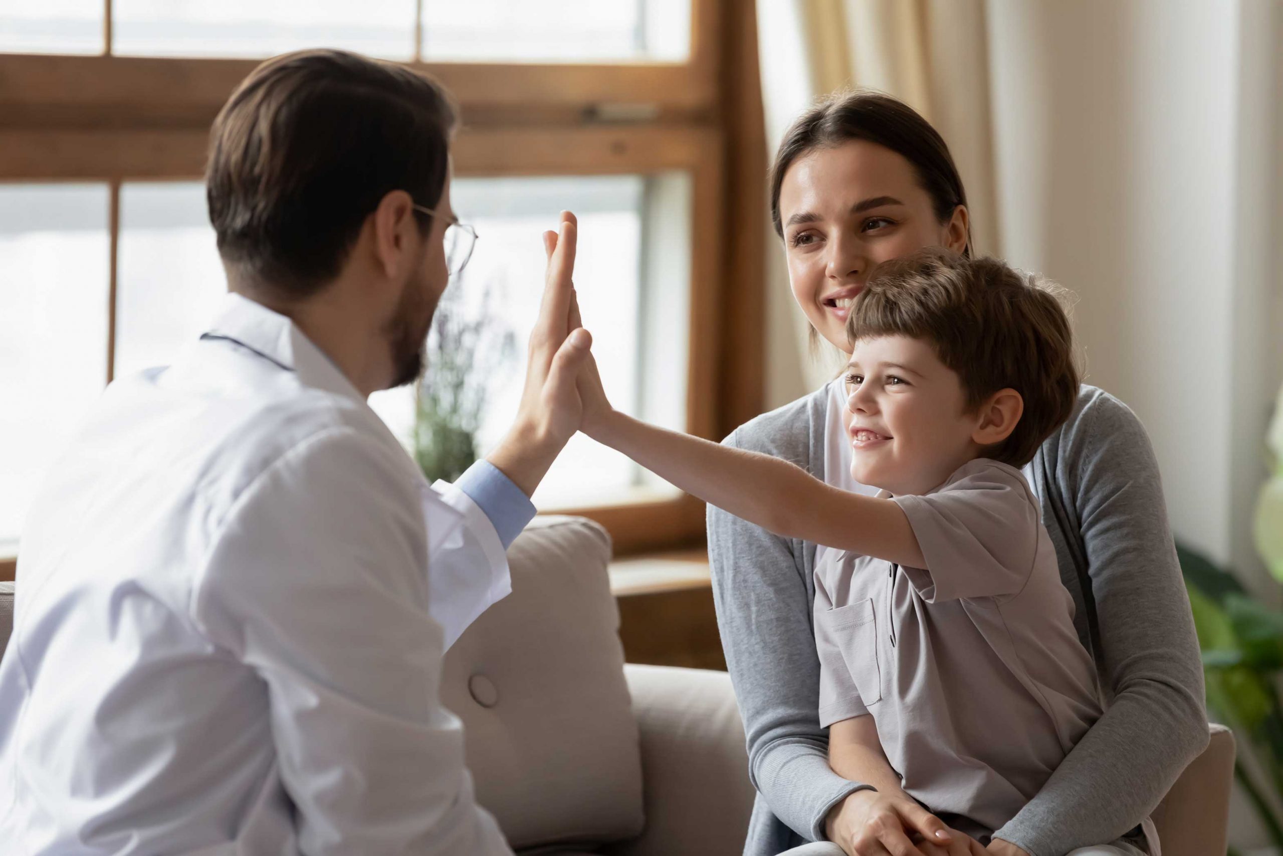 Happy little boy with mum giving high five to dad. Discussing future of superannuation