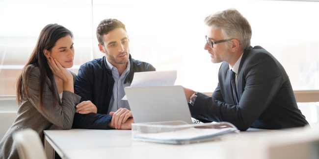 couple speaking to financial advisor to look at their cryptocurrency investments