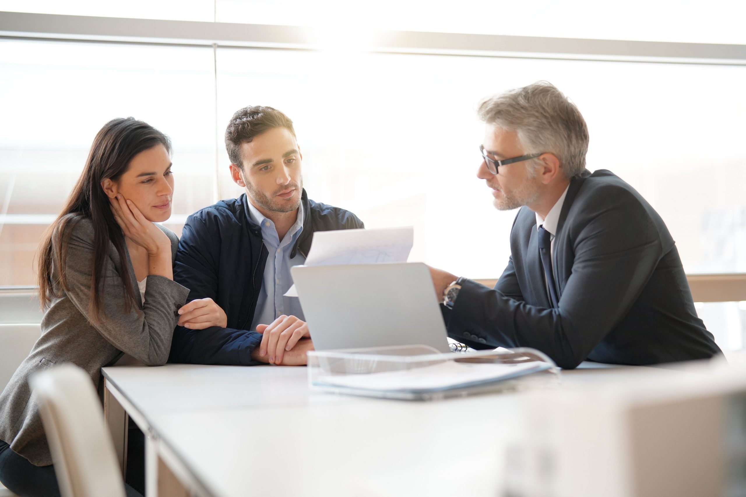 couple speaking to financial advisor to look at their cryptocurrency investments